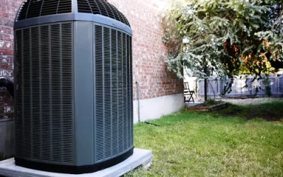 Should I cover my outdoor AC unit to protect it from rain?